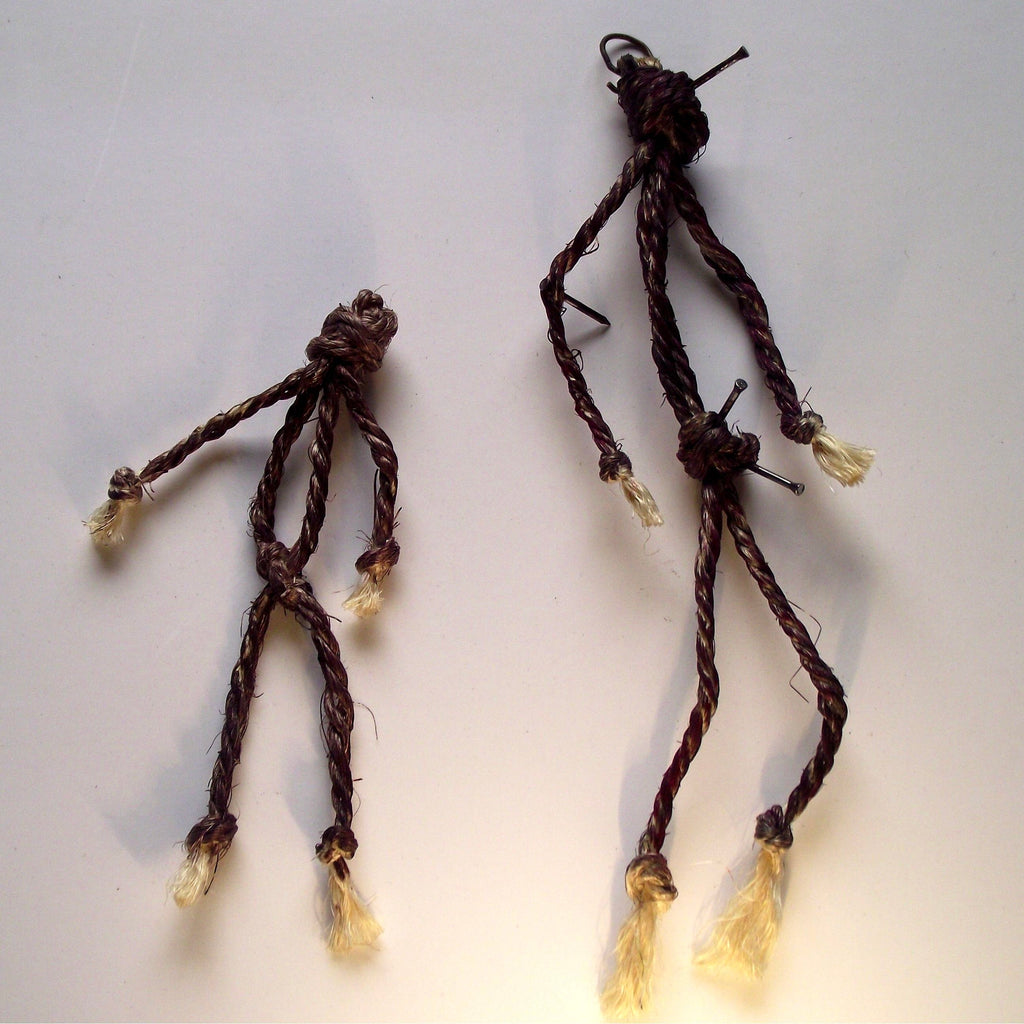 Two handmade braided cord dolls with cream-colored frayed ends and nails in their body, displayed on a plain light background. Introduction to January Full Moon Workshop - Mastering Magical Poppets